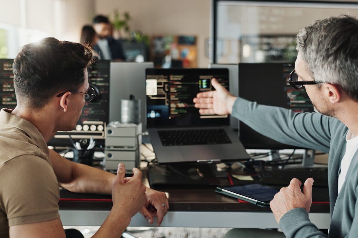 Two engineers pairing at a laptop